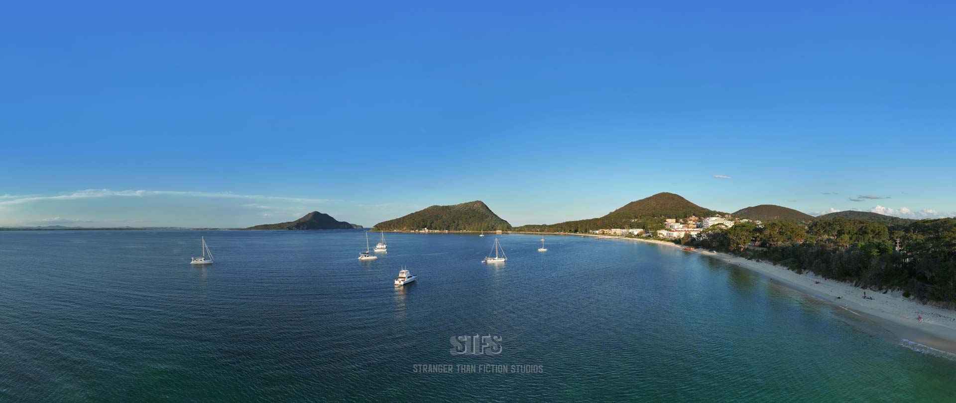 Panoramic Drone Image Of Shoal Bay With Boats Moored In Front Of Tomaree Headland And The Shoal Bay Country Club In Port Stephens NSW